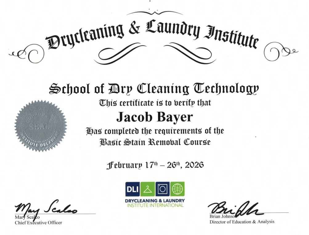 A certificate from the Drycleaning & Laundry Institute awarded to Jacob Bayer for completing the Basic Stain Removal Course, dated February 17&ndash;26, 2026.