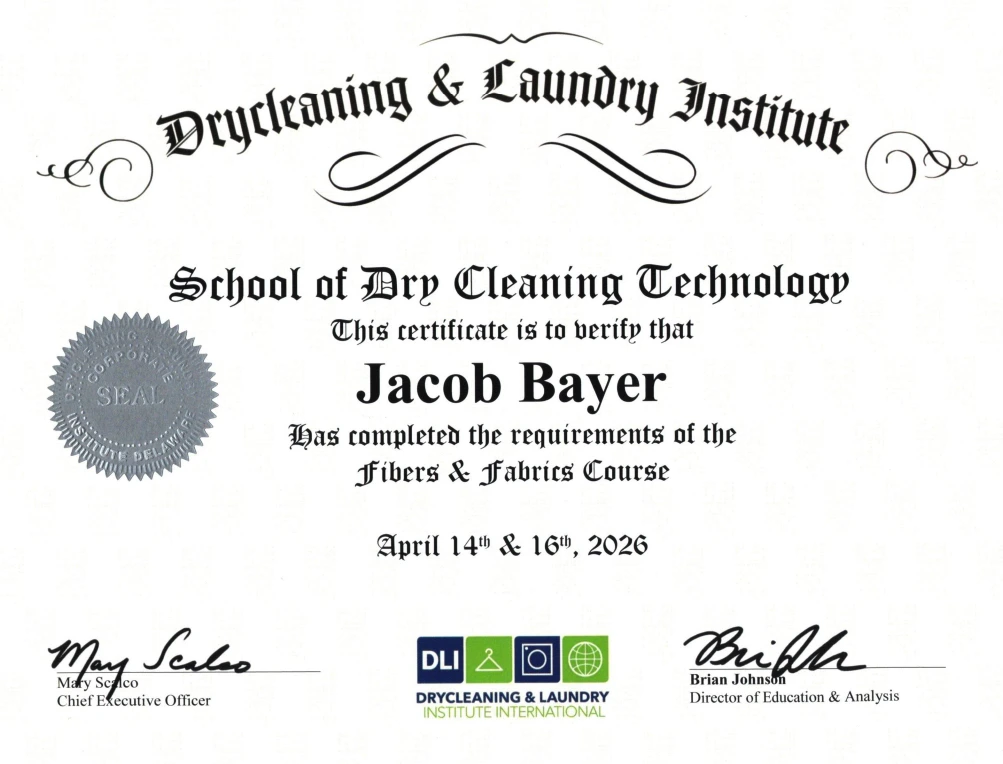 Drycleaning & Laundry Institute certificate awarded to Jacob Bayer for completing the Fibers & Fabrics Course on April 14th & 16th, 2026, with official signatures and seal.